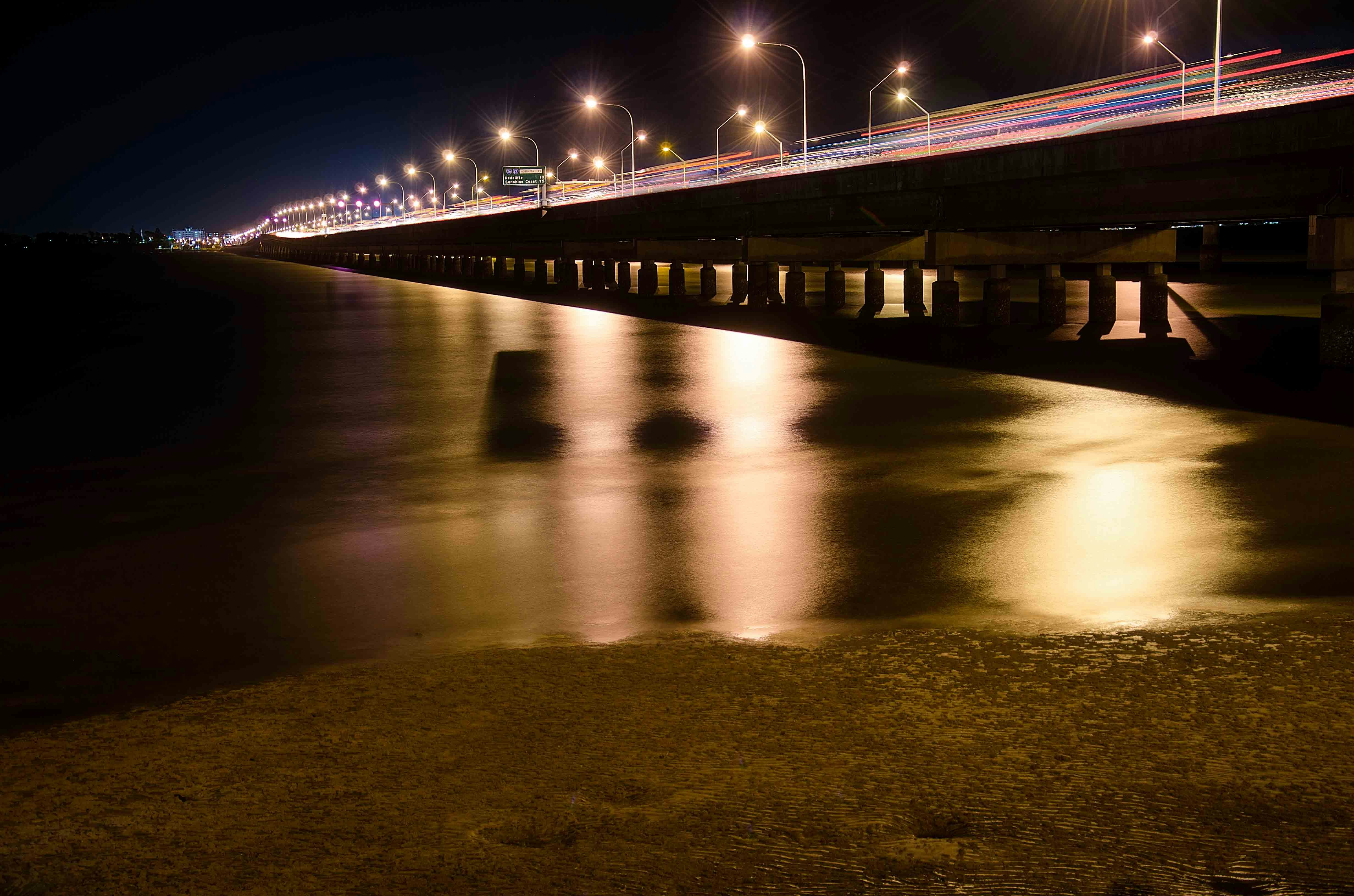 brown wooden dock on body of water during night time