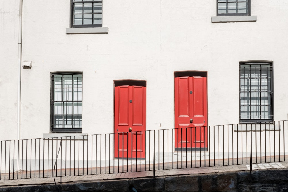 red door on white concrete building