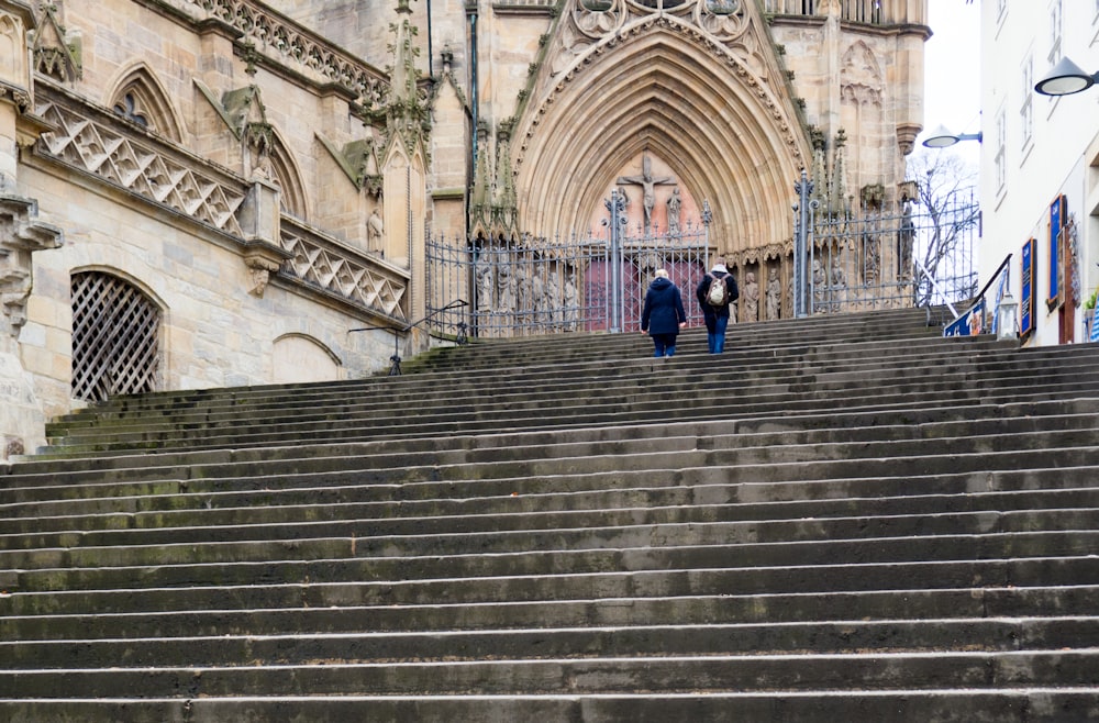 woman in blue jacket walking on stairs