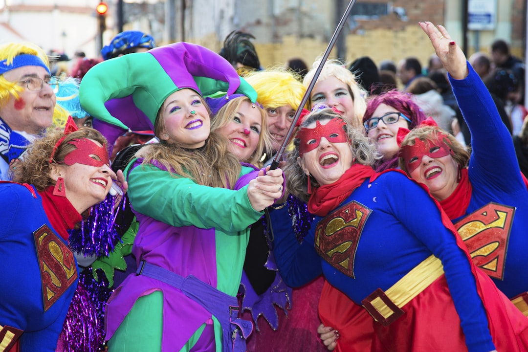 group of people wearing purple and pink jacket, Durante el carnaval de Málaga.