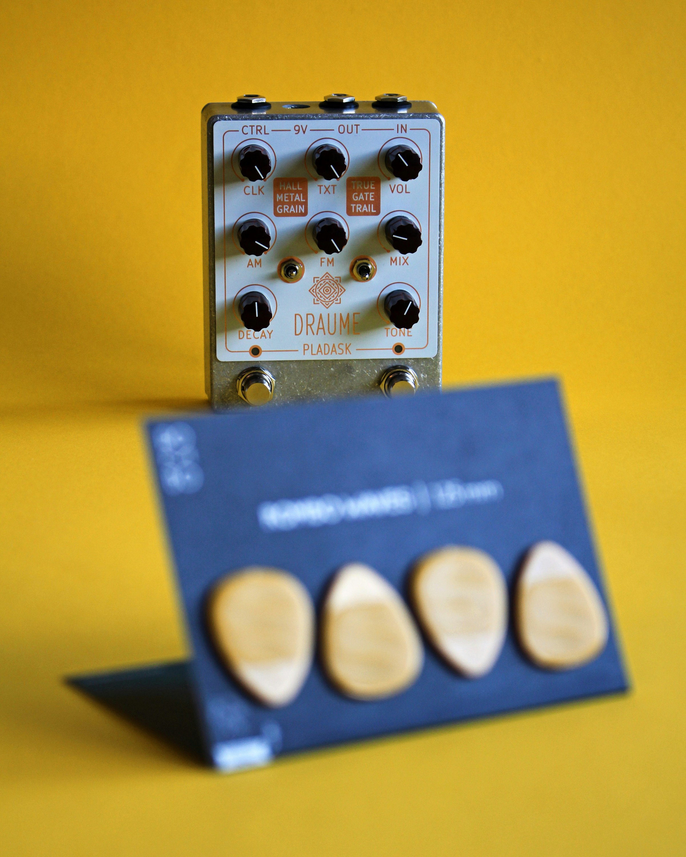 a couple of wooden buttons sitting on top of a blue box