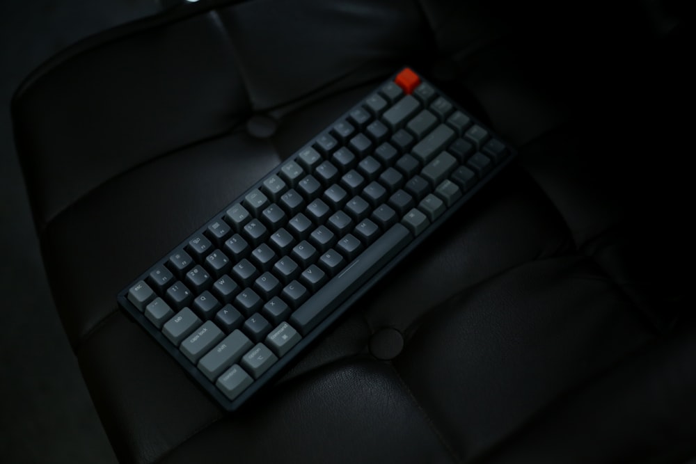 black computer keyboard on black leather couch