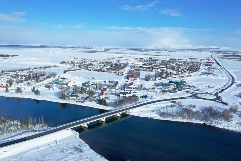 white and black houses near body of water under blue sky during daytime