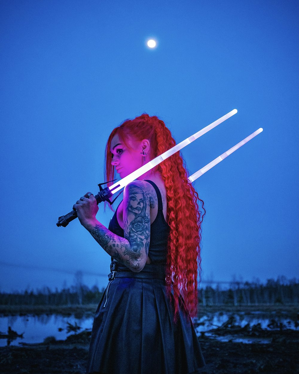 woman in red and black dress holding white stick