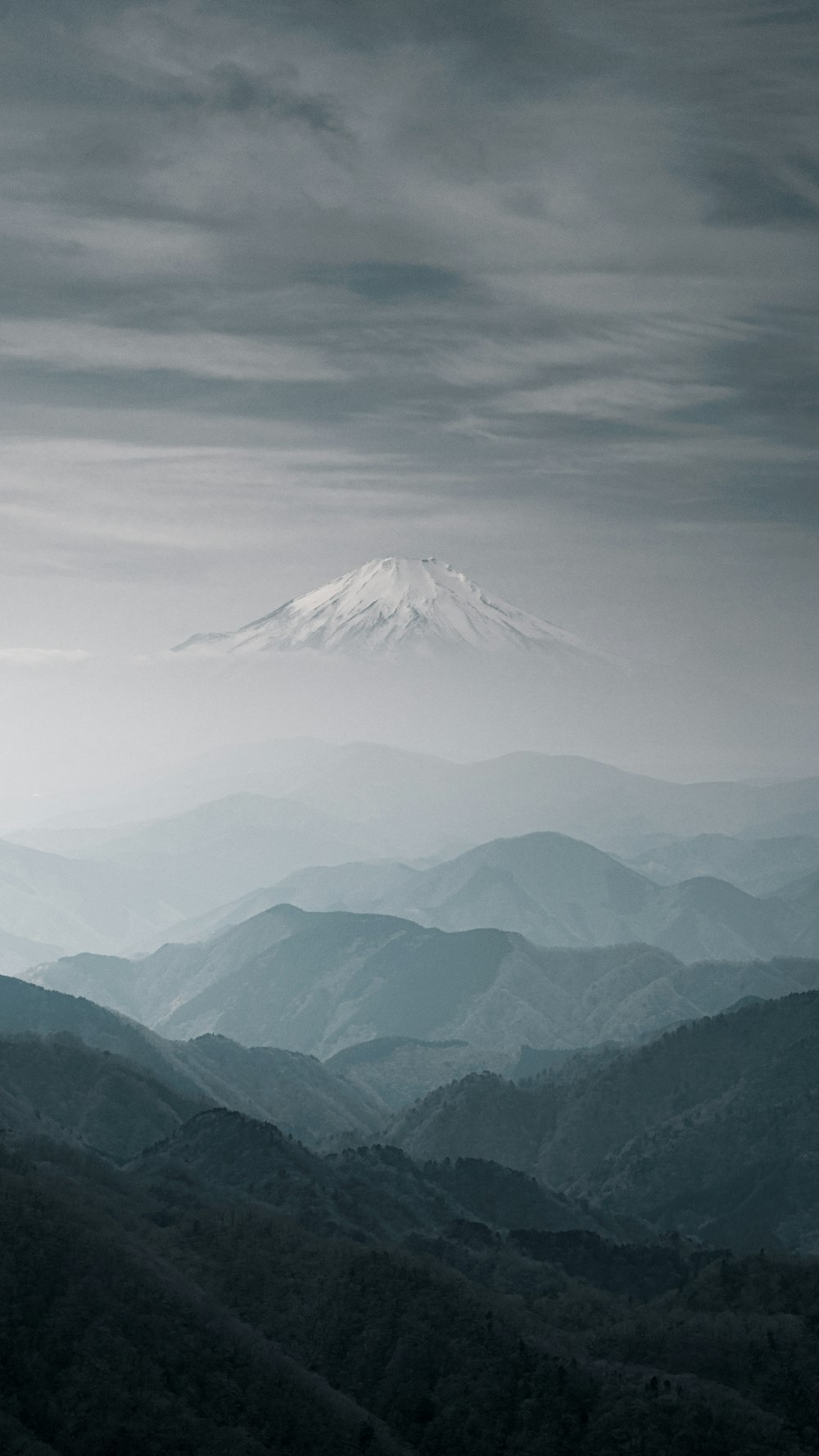 snow covered mountain under cloudy sky during daytime