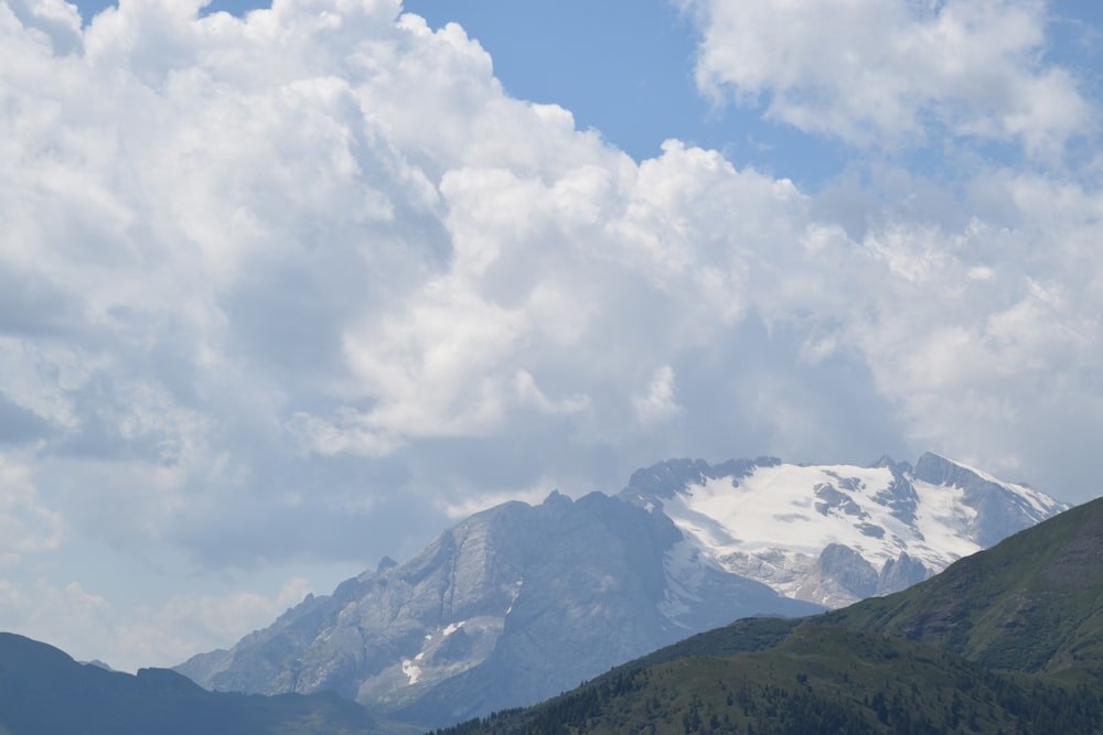 white clouds over green mountains