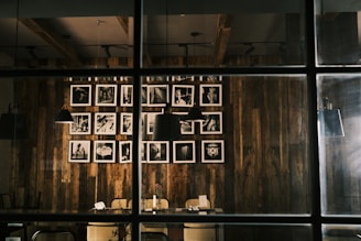A cozy indoor space showcasing black and white photography on rustic wooden panels.