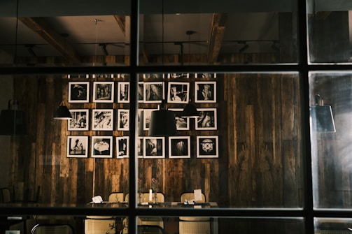 A cozy indoor space showcasing black and white photography on rustic wooden panels.
