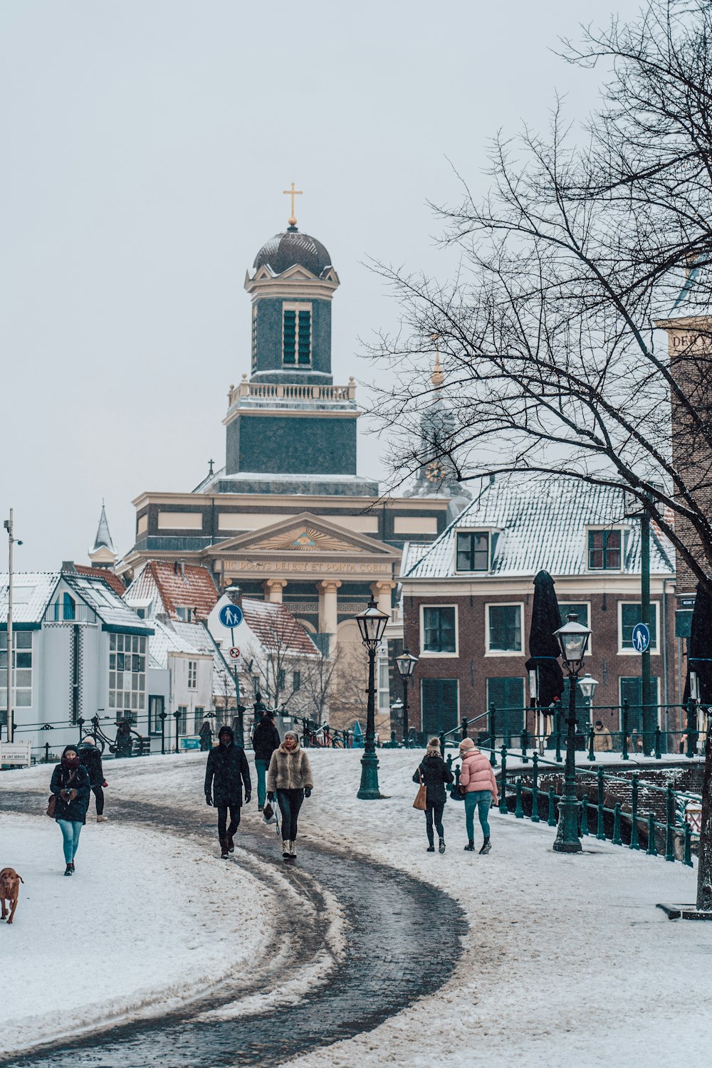 people walking on street near brown building during daytime