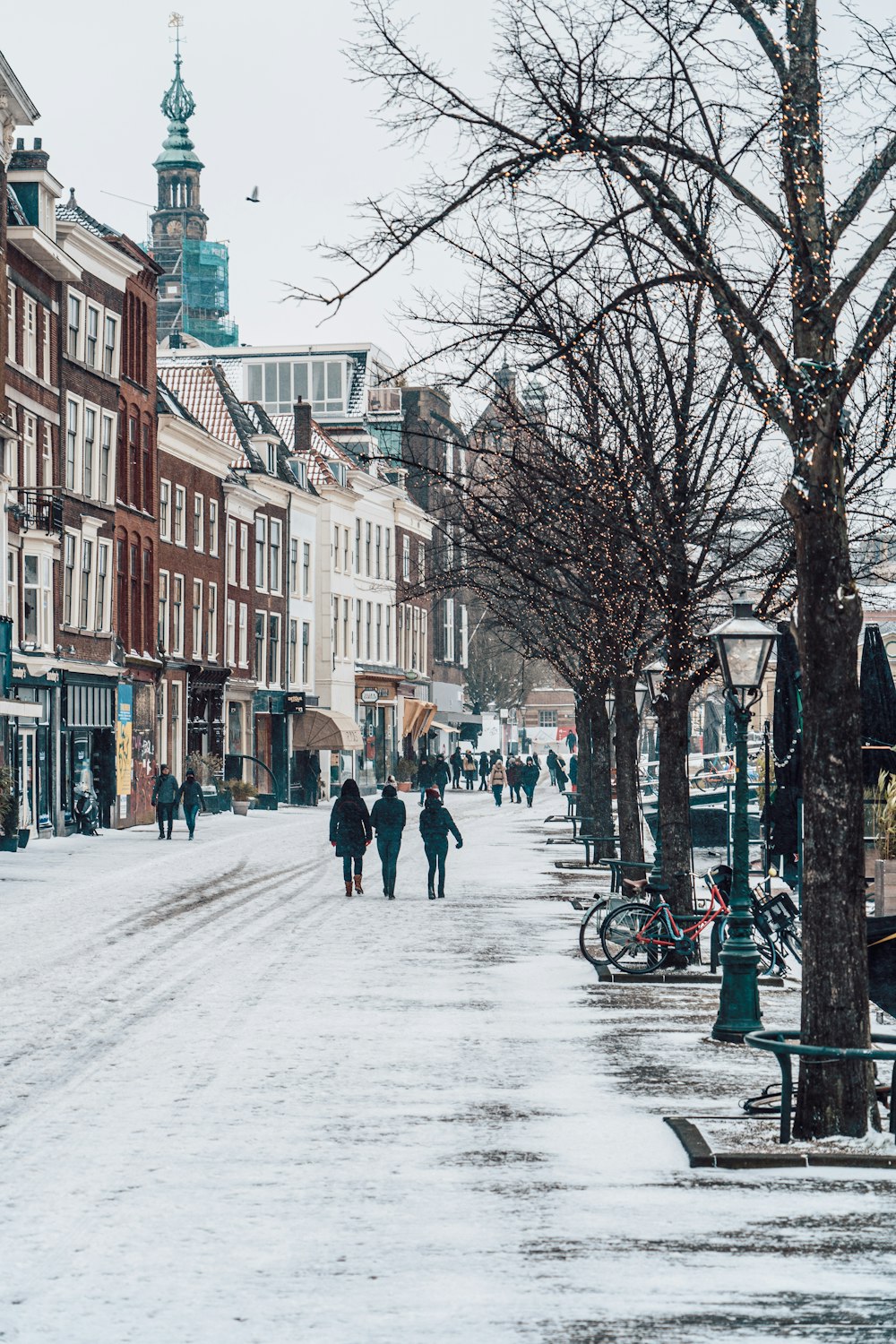 people walking on snow covered road during daytime