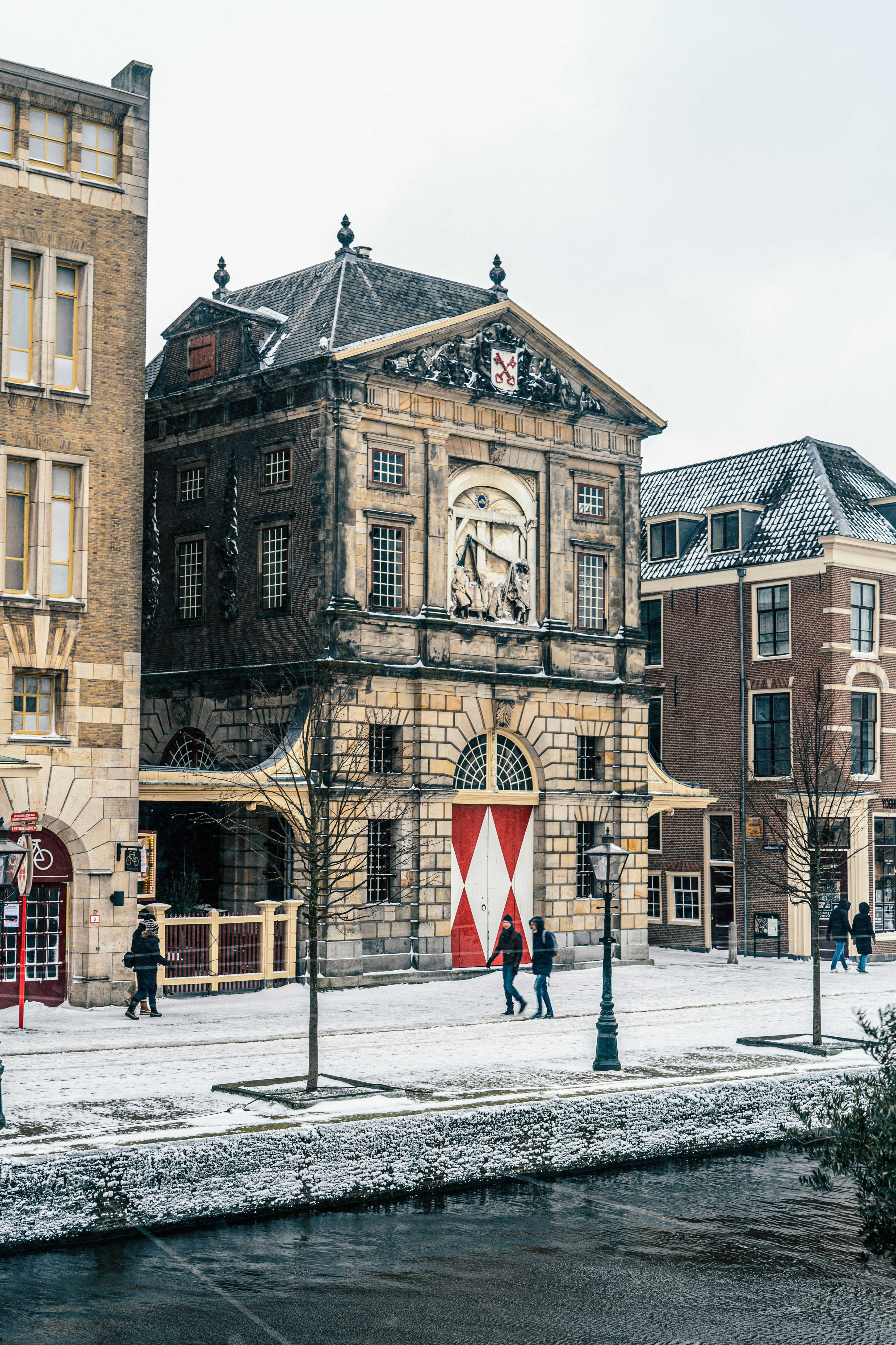 brown concrete building with snow covered ground during daytime