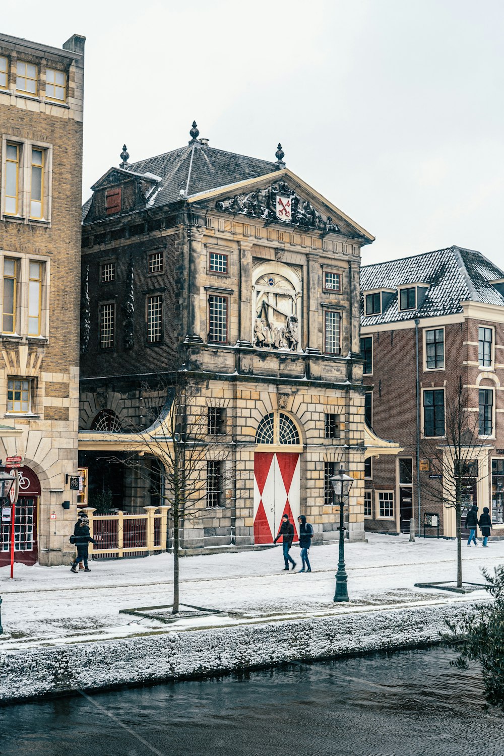 brown concrete building with snow covered ground during daytime