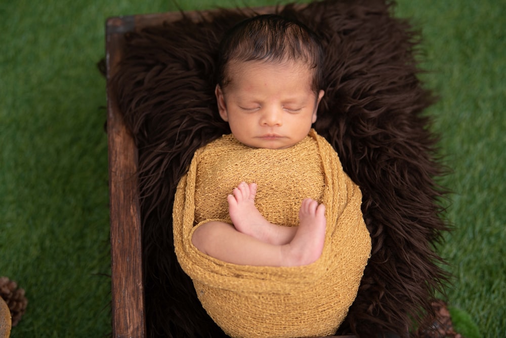 girl in yellow knit sweater lying on brown fur textile