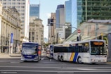 blue and white bus on road during daytime