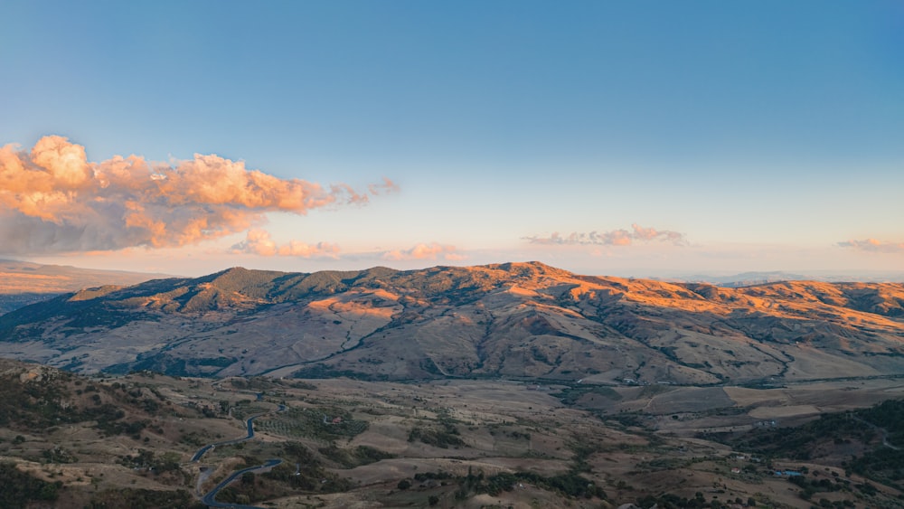 aerial view of mountains under blue sky during daytime