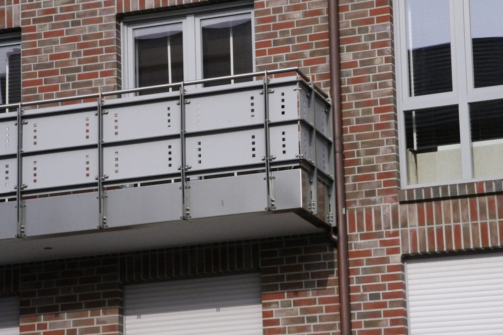 brown brick building with white wooden window