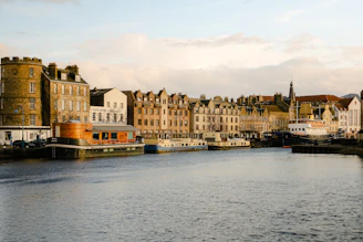 A scenic view of a historic Southern Maryland waterfront with boats and old buildings under a golden sunset.