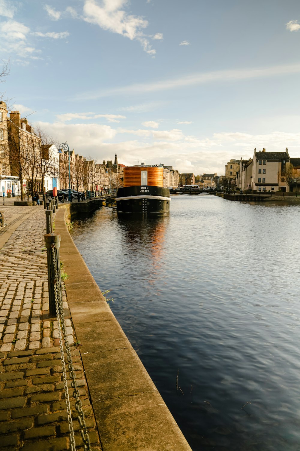 river between buildings during daytime