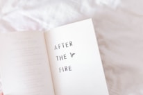 Close-up of the 'After the Storm' book cover resting on a rustic wooden table.