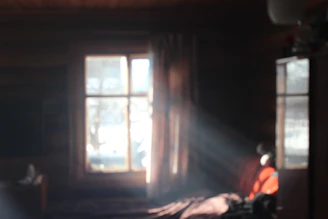 Soft light filtering through a cabin window, highlighting the texture of comfy winter wear.