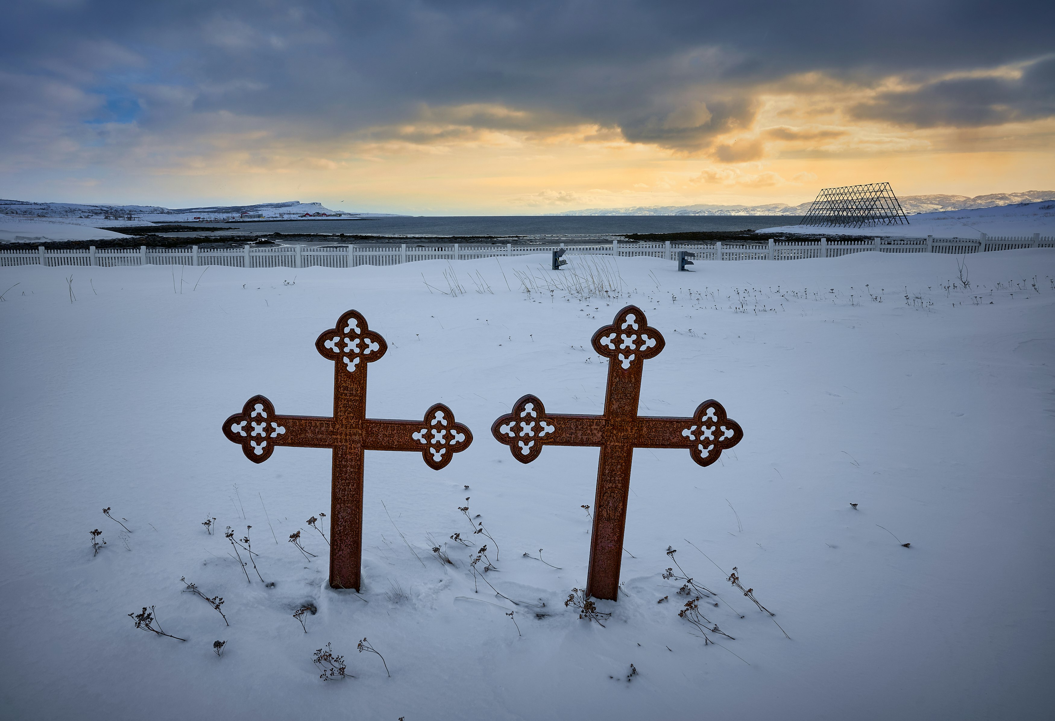 brown wooden cross on snow covered ground during daytime