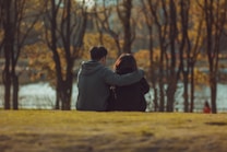 man and woman standing on brown field during daytime