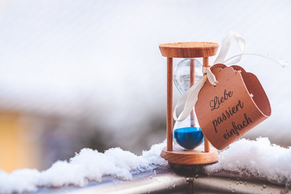 brown wooden hour glass on white snow