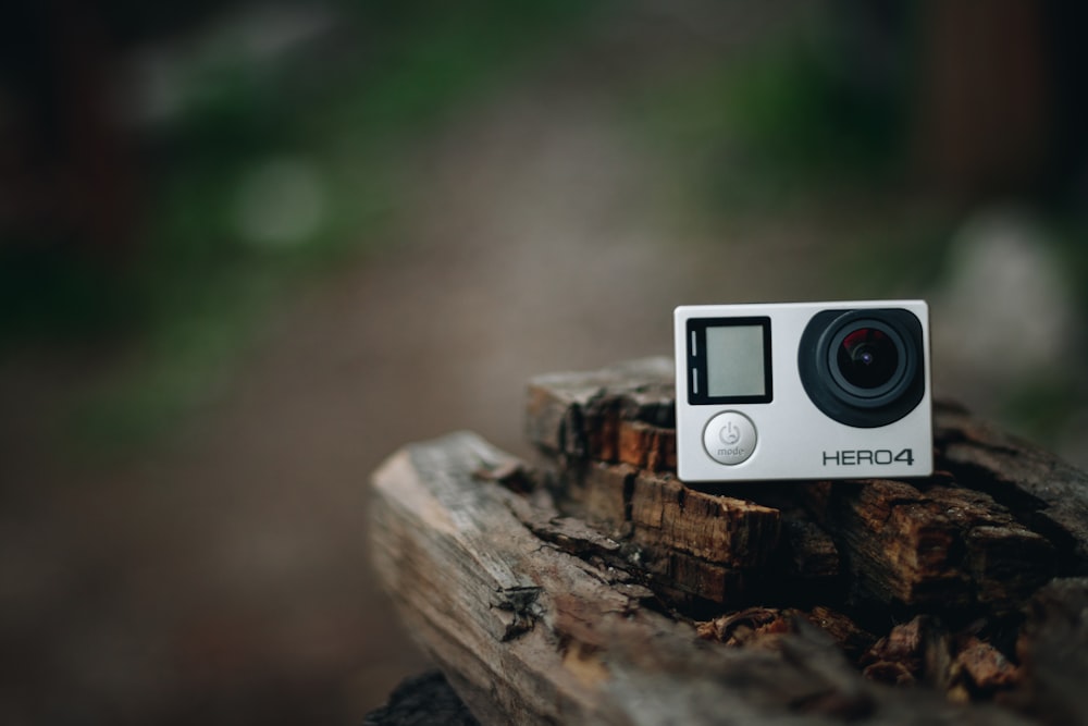 black and silver camera on brown wood