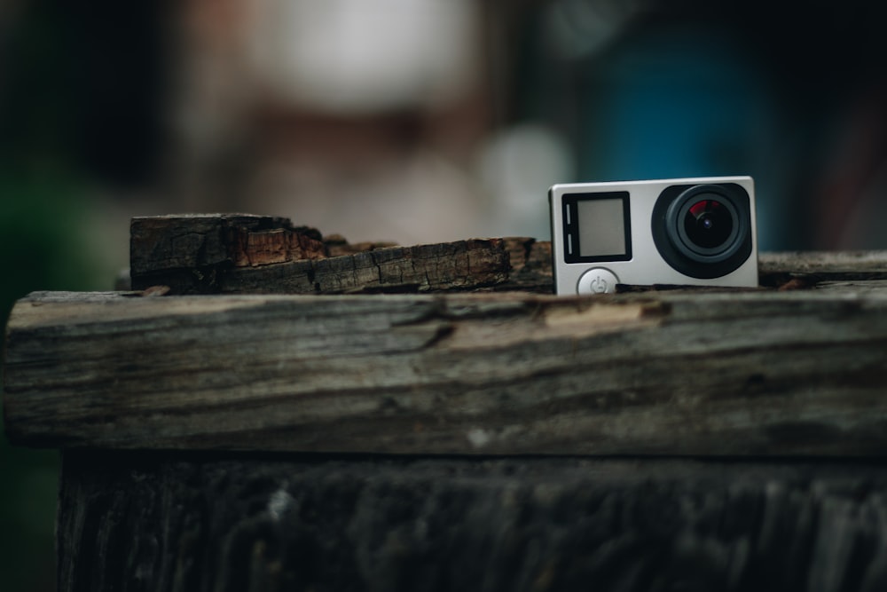 white and black camera on brown wooden surface