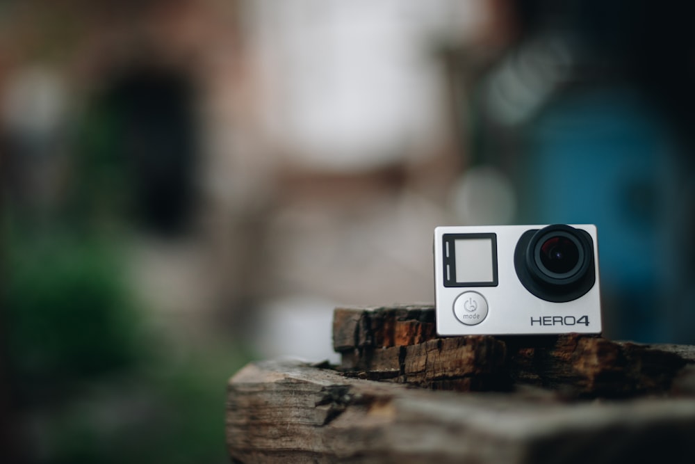 black and silver camera on brown wood