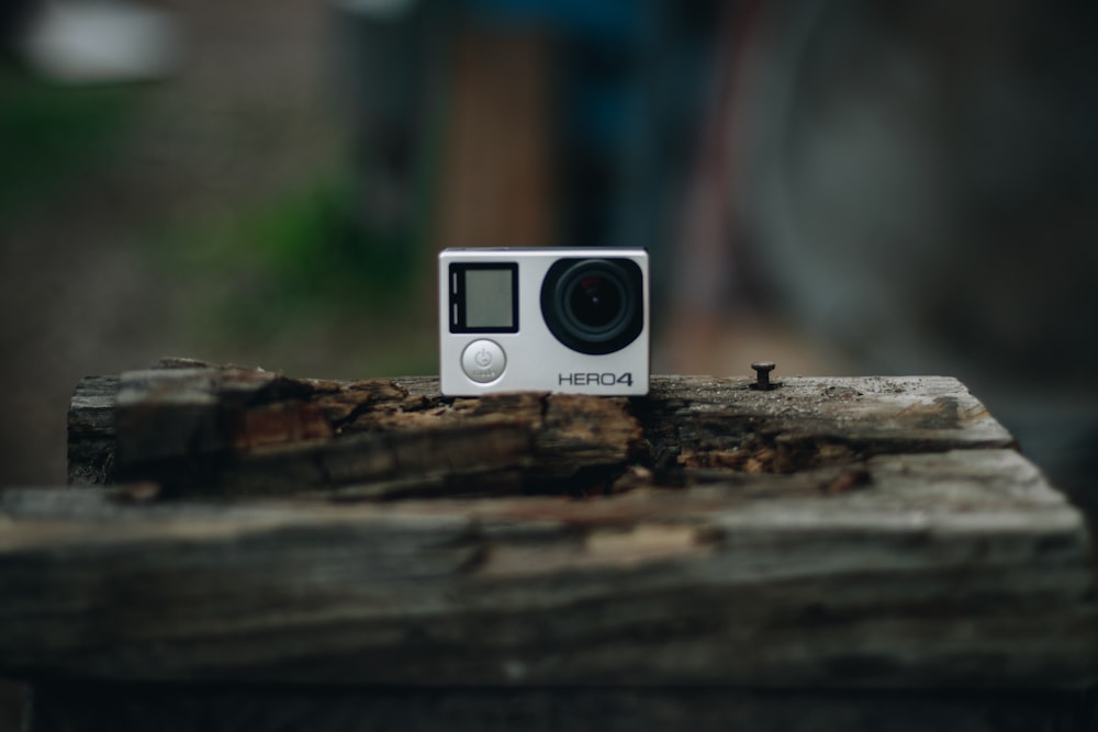 white and black camera on brown wooden surface