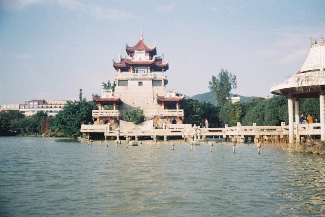 white and brown concrete building near body of water during daytime