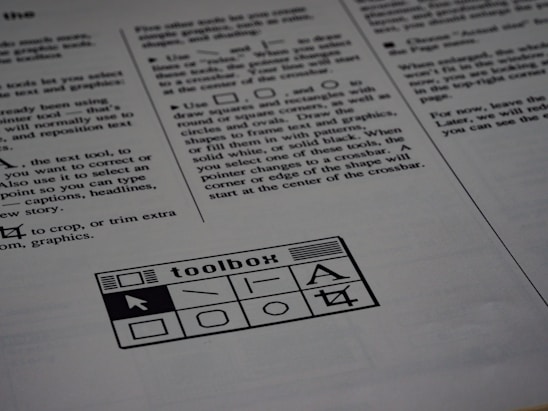 A printed page of text is visible, featuring instructions and explanations related to drawing tools and text editing. In the bottom section of the page, there is a graphic of a toolbox with various tool icons including a text tool and shape tools.