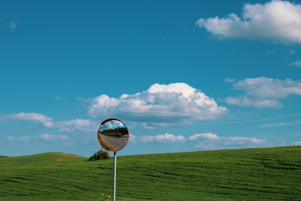 black and white basketball hoop on green grass field under blue sky during daytime