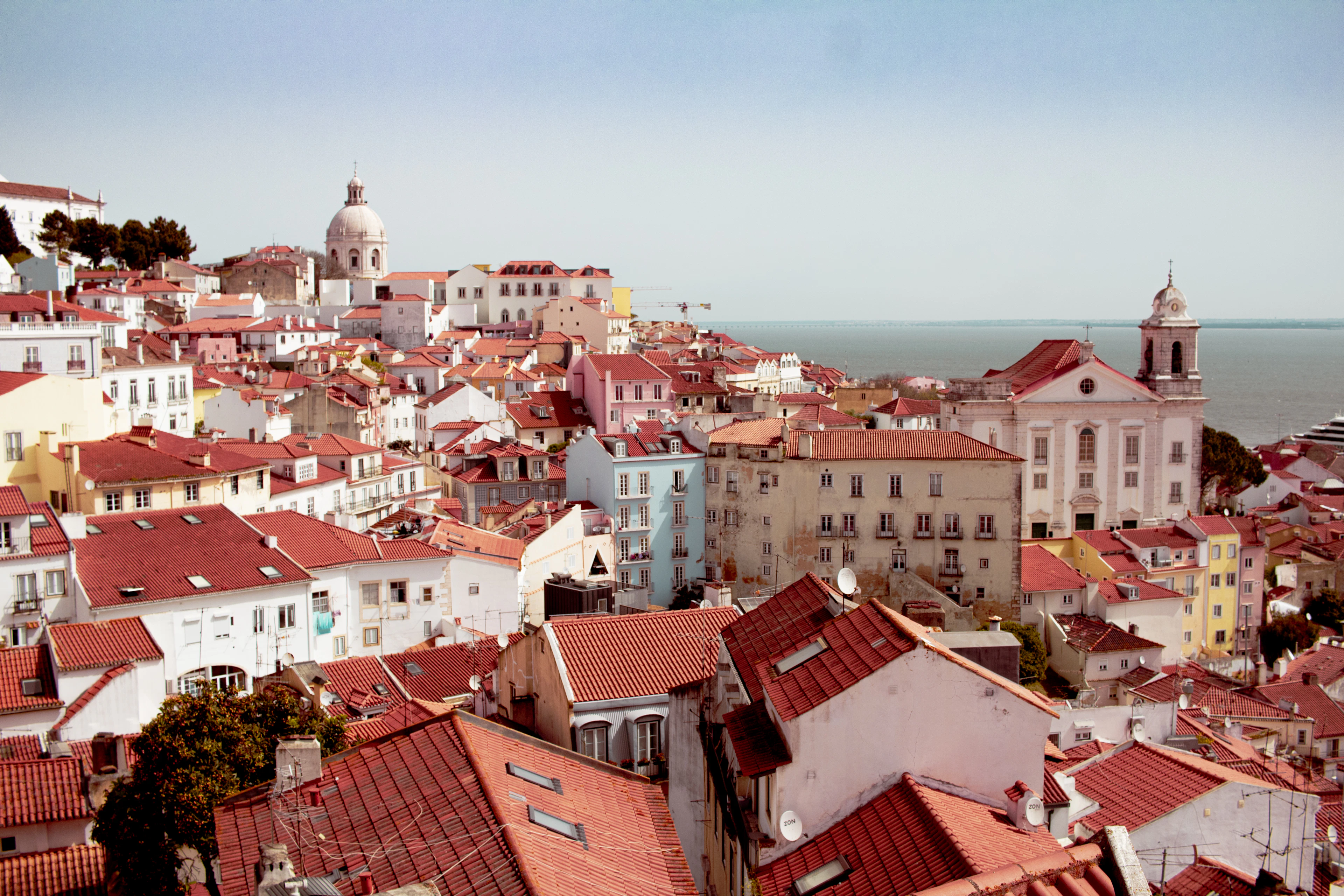 Terracotta rooftops of Lisbon running down to the river