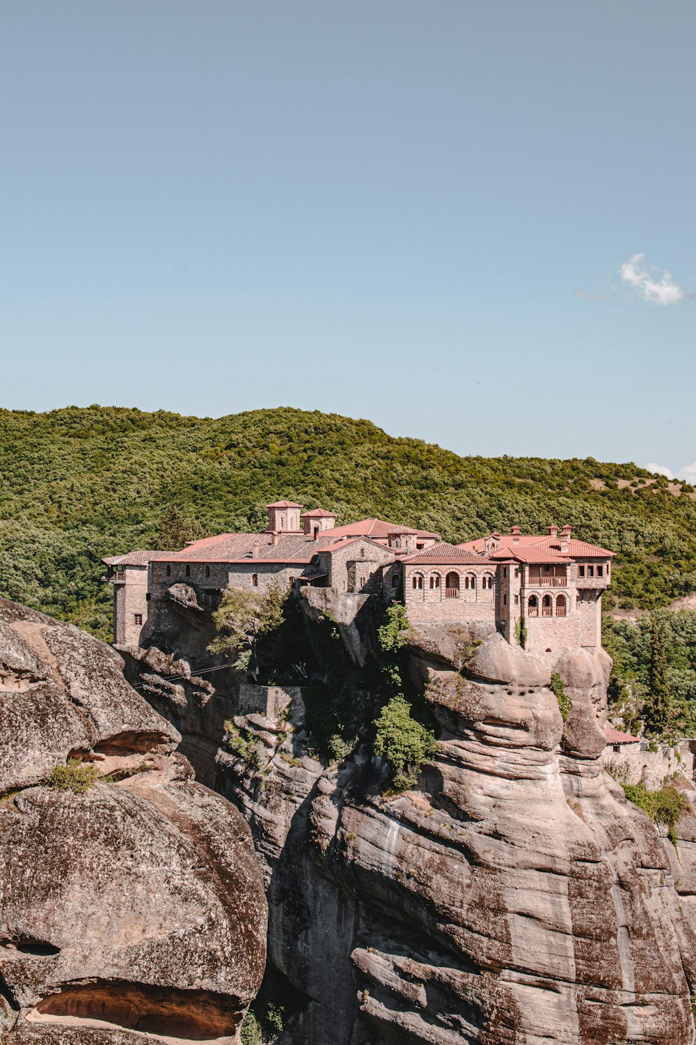 brown concrete building on top of mountain during daytime