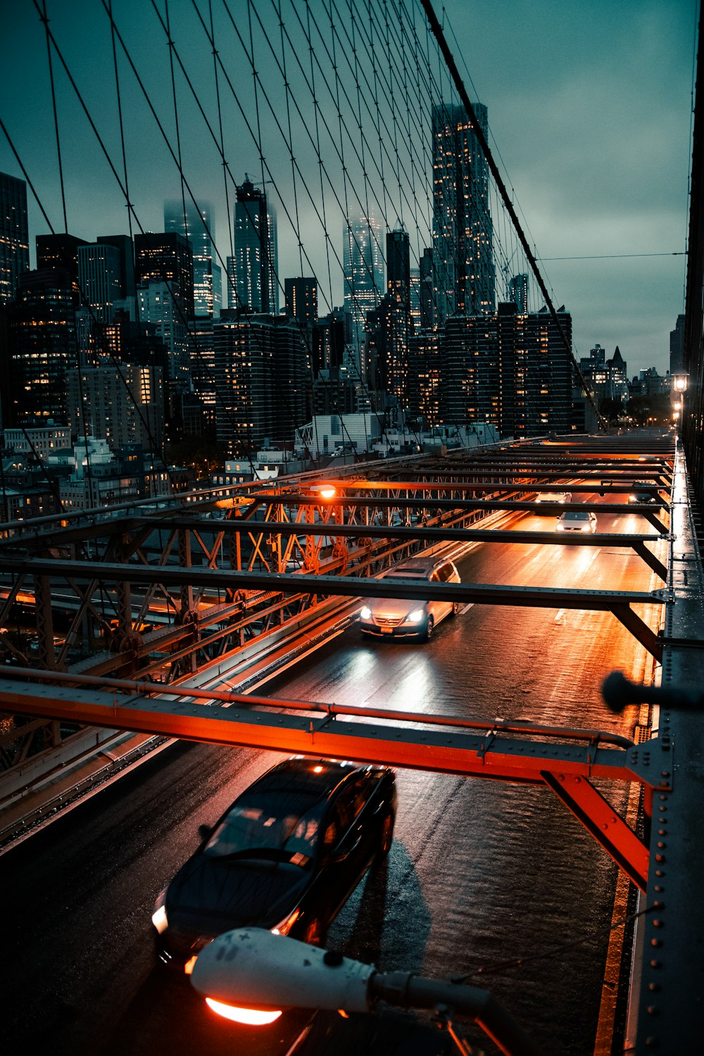 cars on road near city buildings during night time