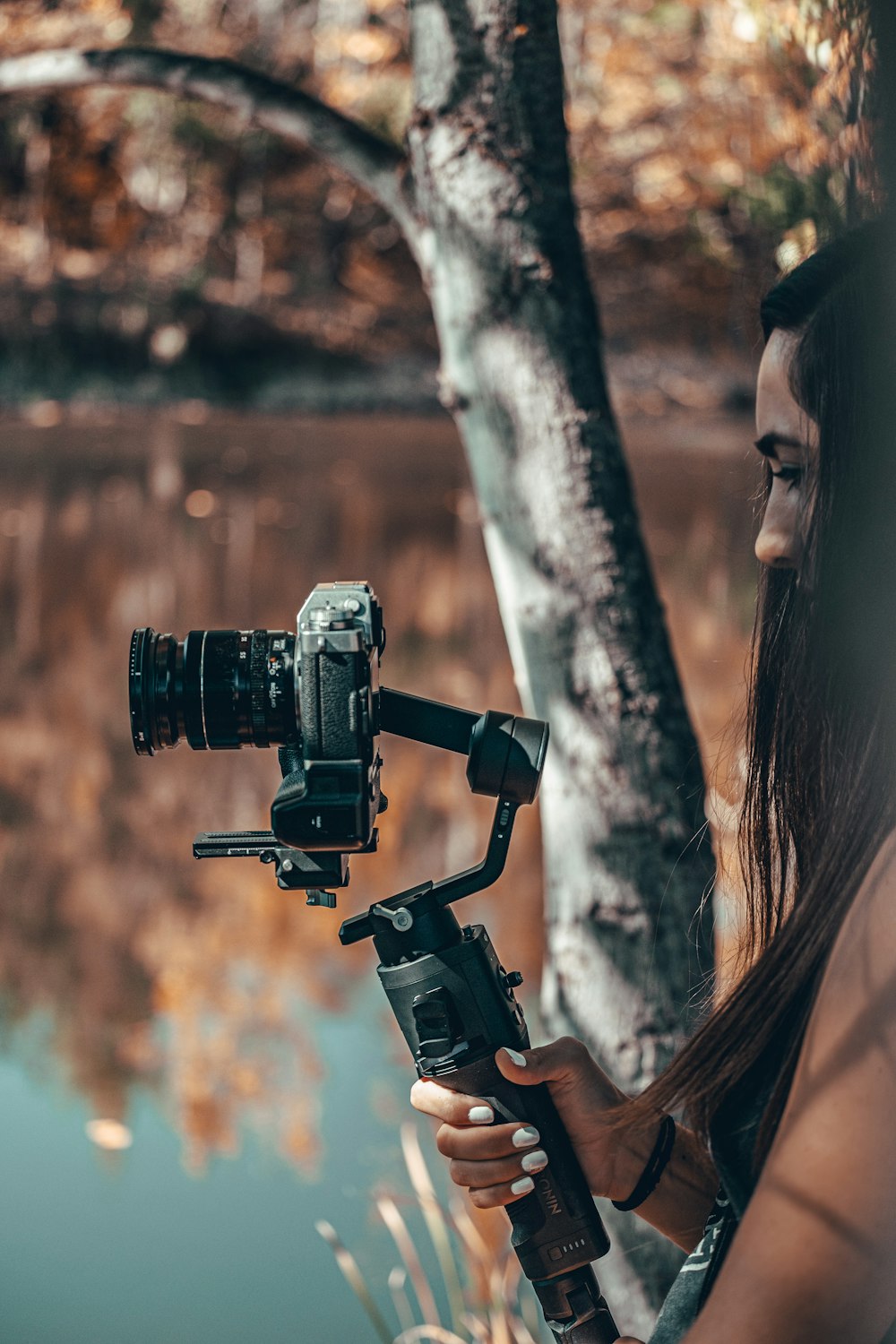 woman taking photo using dslr camera