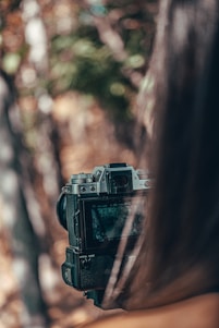 A photographer capturing a vibrant outdoor scene with a camera.