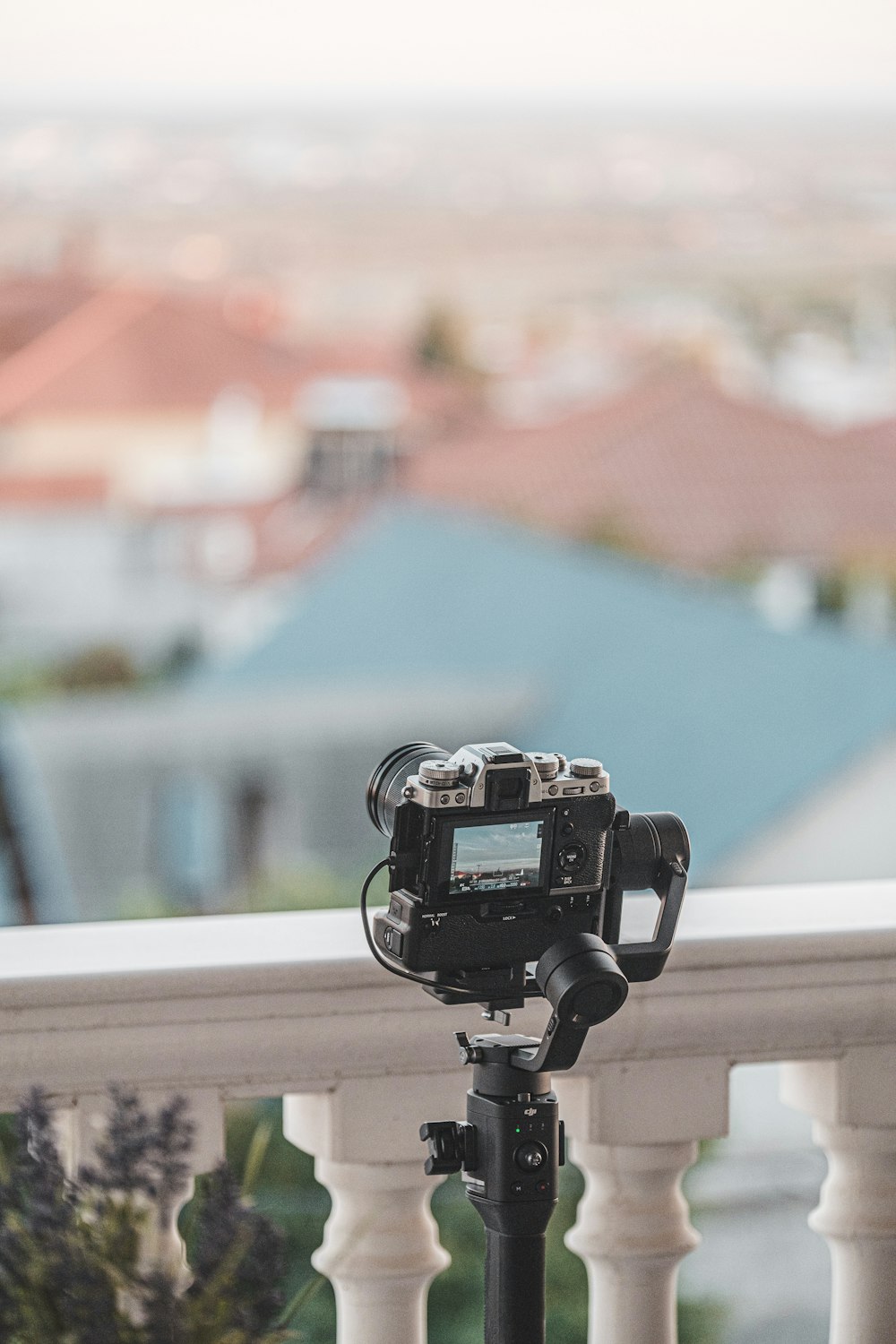 black dslr camera on white wooden table