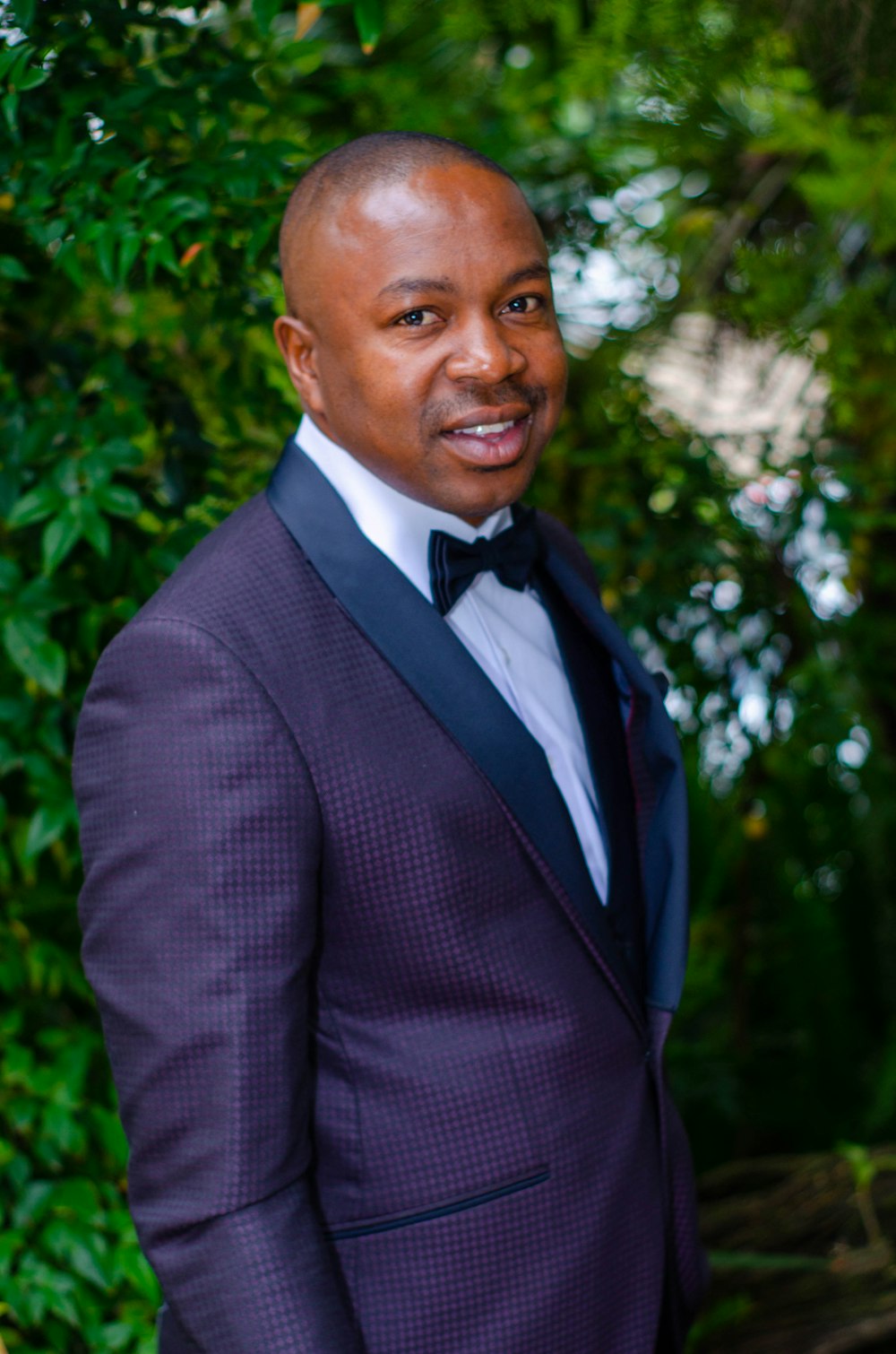 man in black suit jacket smiling