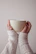 Close-up of hands holding a soft, neutral-colored custom mug from éclat doux.