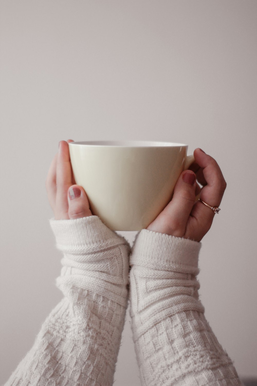 person holding white ceramic mug