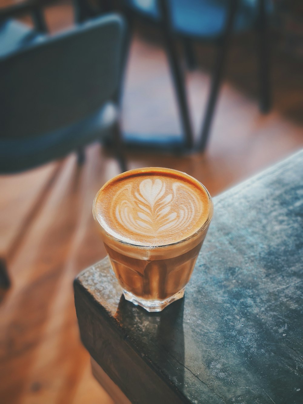 brown and white coffee cup on gray table