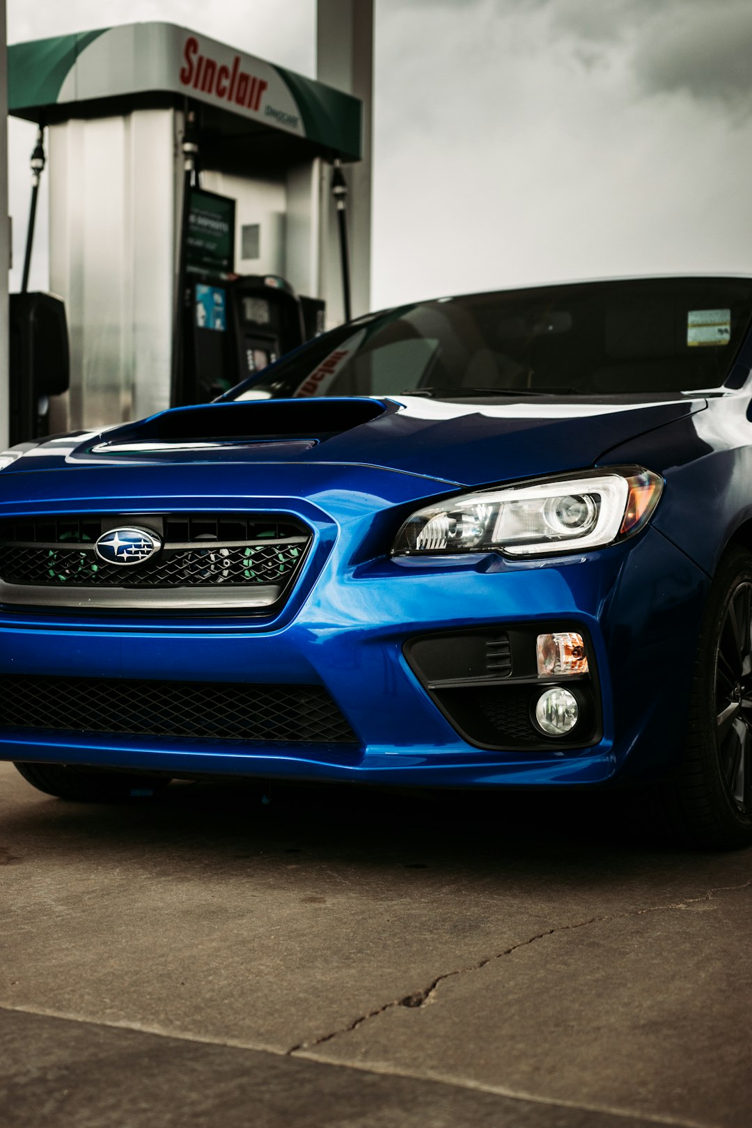 blue nissan car parked in garage