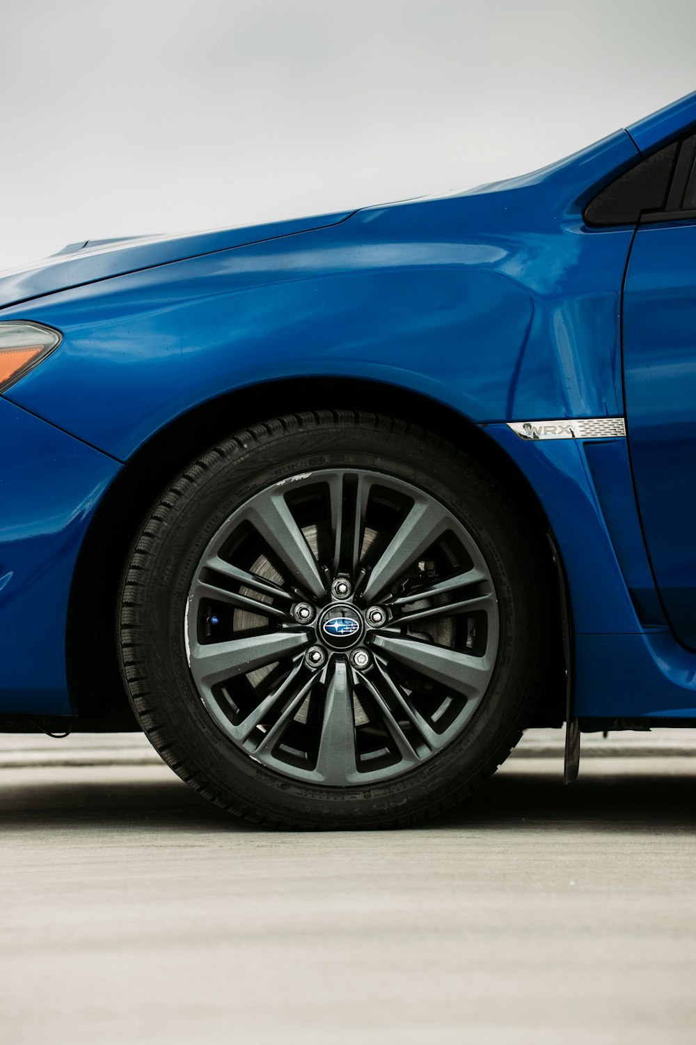 blue car on gray asphalt road during daytime