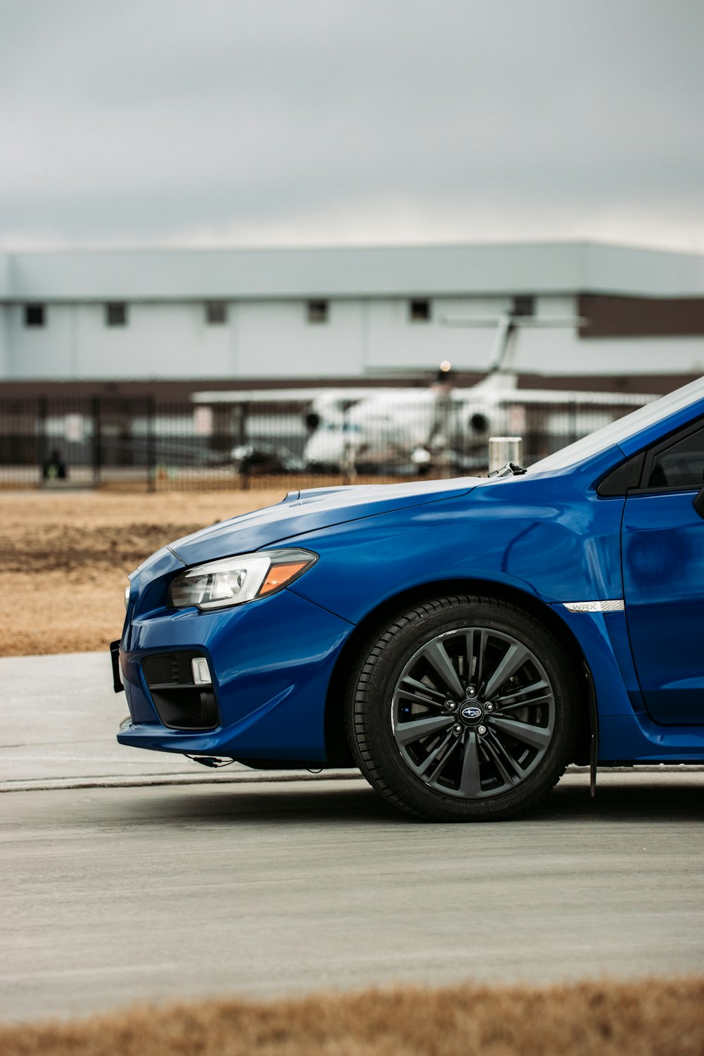 blue car on gray asphalt road during daytime