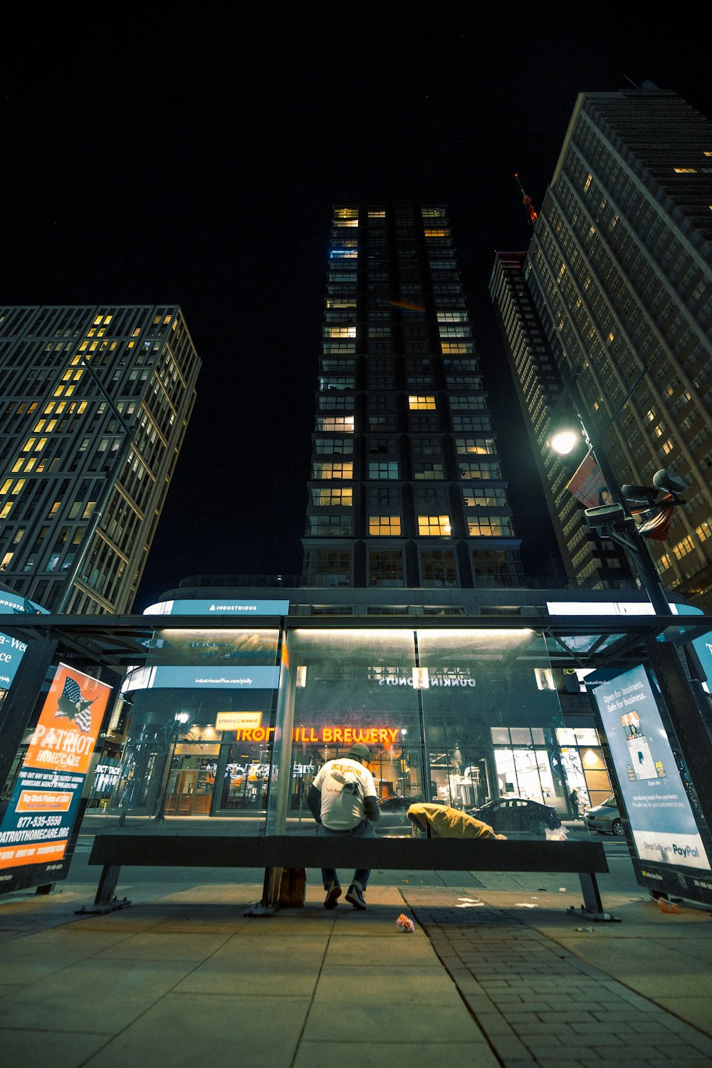 people walking on street near high rise building during night time