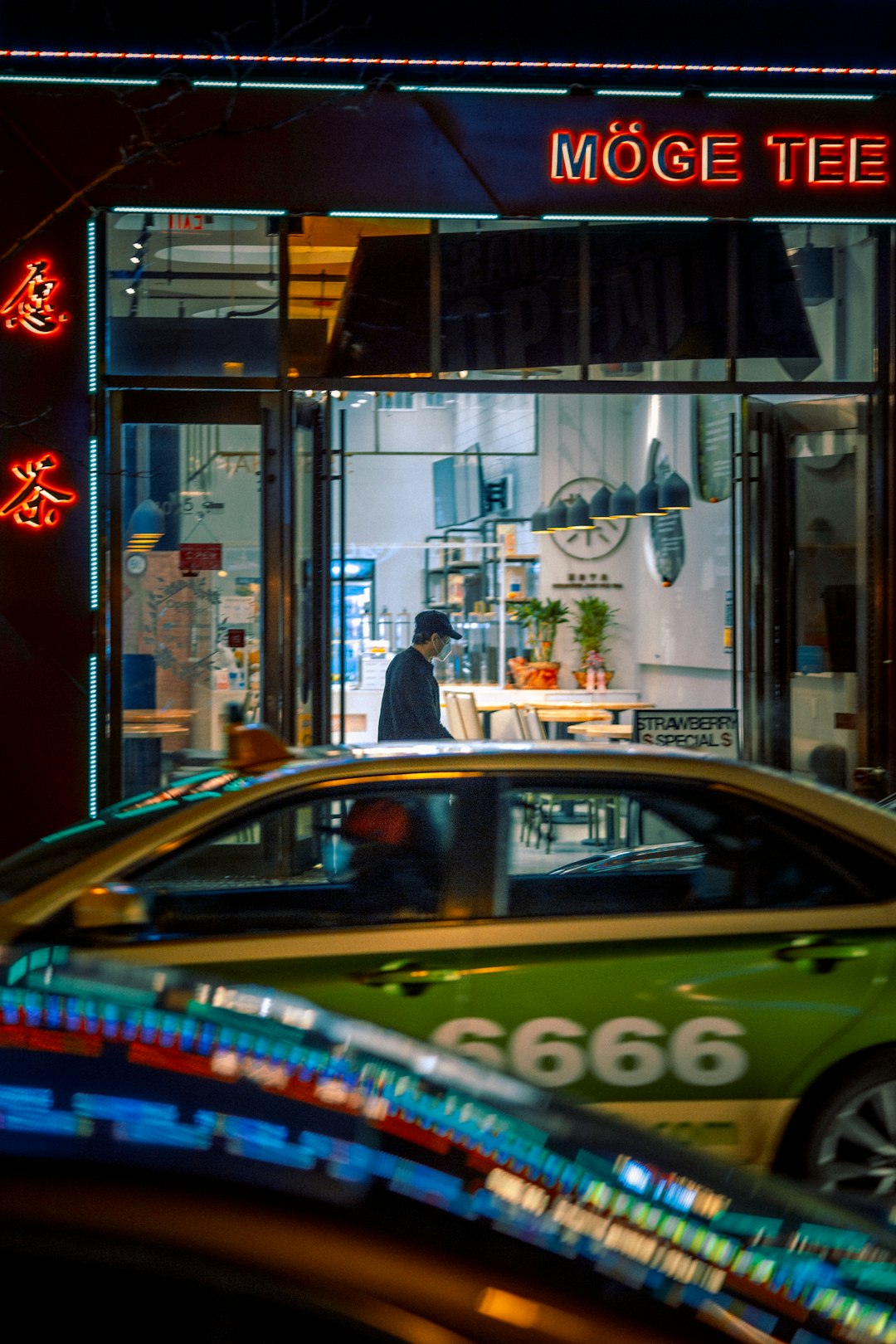 cars parked in front of store during night time