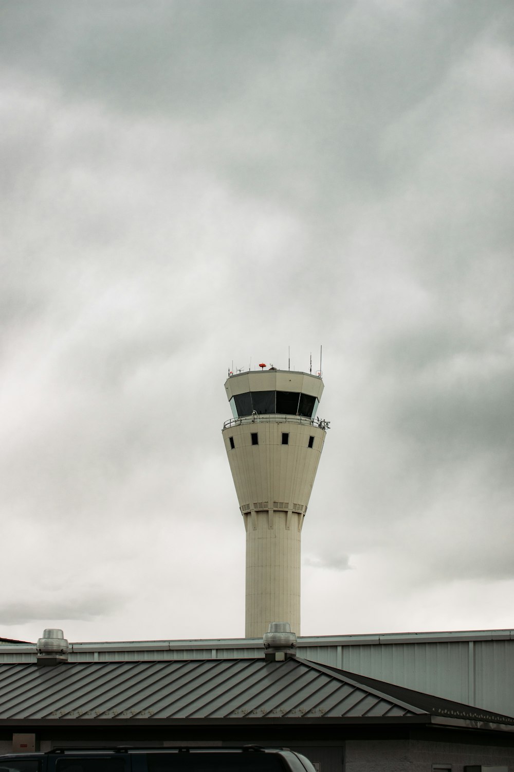 white concrete tower under white clouds